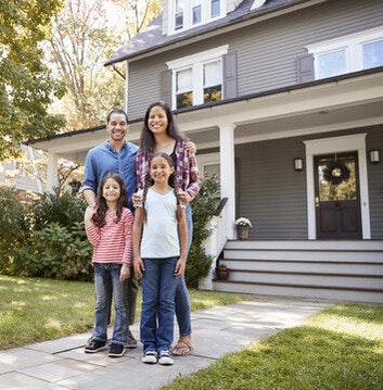 Happy Family in front of Houses