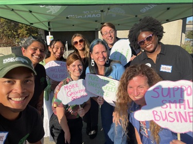 Close up of Oakland Strategic Planning team holding feedback option signs