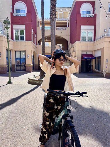 Person holding helmet while on bike