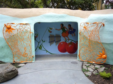 The entrance to a play area at Fairyland. The entrance has two orange ornamental gates. 