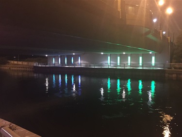 A colorful light installation reflecting on the water. 