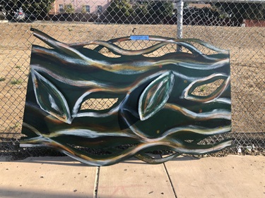 A piece of the painted metal gateway prior to assemblage and installation.